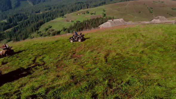 Male Tourists Riding Quad Bikes in Mountain alt