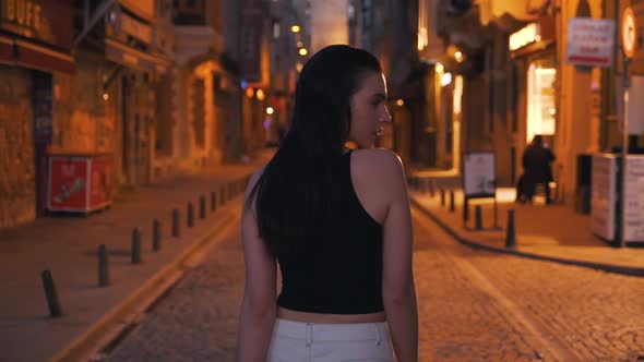 Girl Walking the Streets of the Evening City