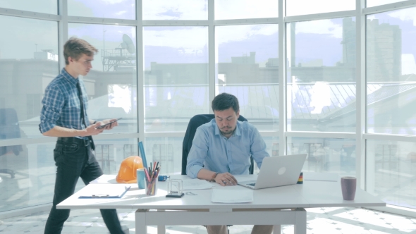 Director Discuss Project With Employee, Gives Advice, Using Digital Tablet In New Modern Office. alt