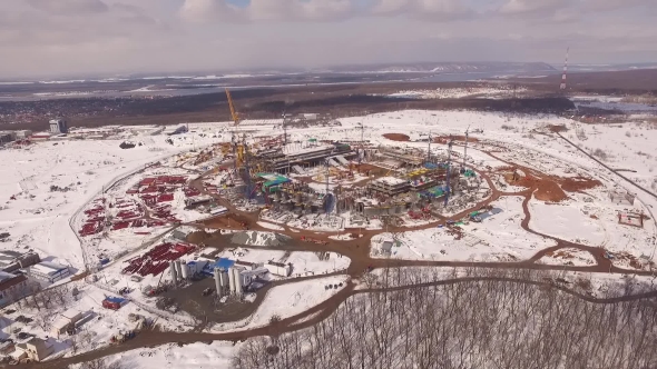 Aerial Panorama Of Stadium Construction Near Bare Forest In Winter