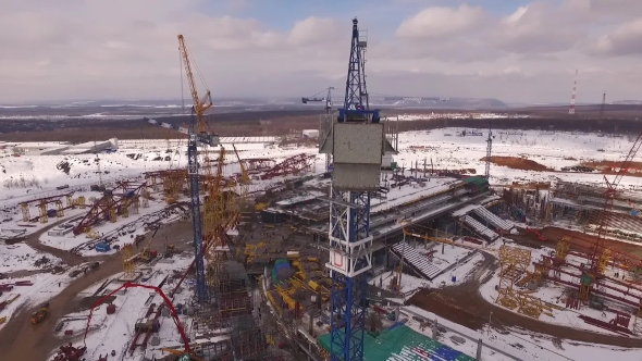Cabin Of Huge Construction Crane On Stadium Building In Winter Time