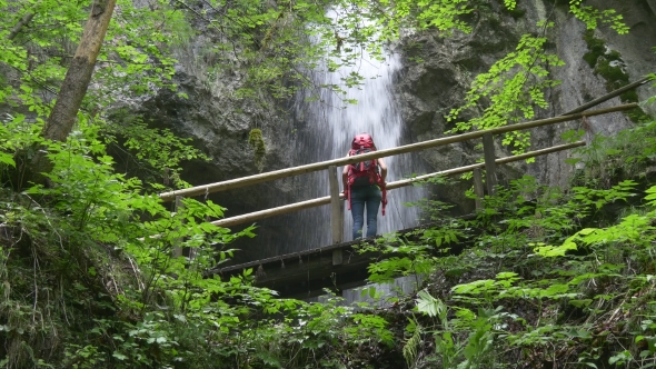 Female Hiker Looking At Waterfall On The Trek