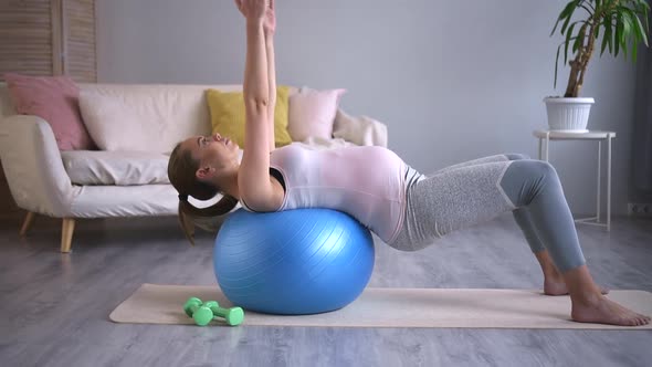 Pregnant Woman Doig Exercise on Ball and Staying in Apartment During Quarantine Spbd alt