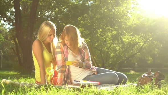 Two Girls Taking Selfie On Green Lawn