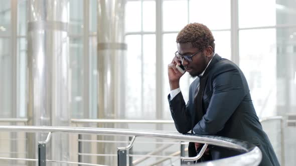 African American manager repotting on mobile phone