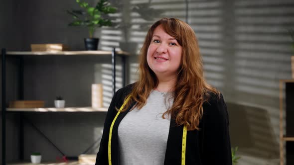 Caucasian Tailor Working at Her Office Looking at Camera and Positively Smiling Small Business alt