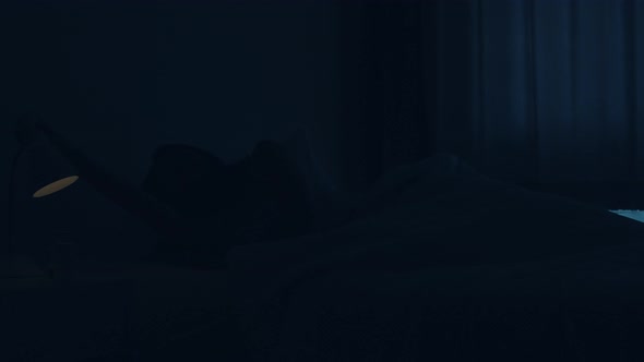 Asian young woman sleeping cozily in her bedroom.female hand turning off on light switch near bed. alt