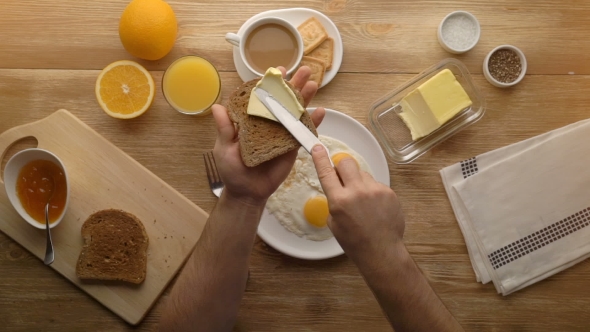 Man Hands Preparing Breakfast Toast With Butter, Top View