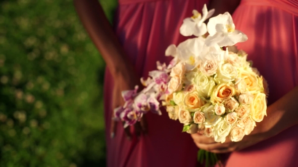 Girlfriend With a Bouquet Of Orchids And Roses In His Hands. .