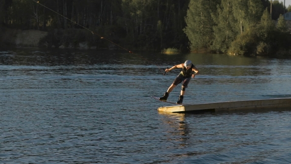 Wakeboarder Making Tricks On Sunset alt