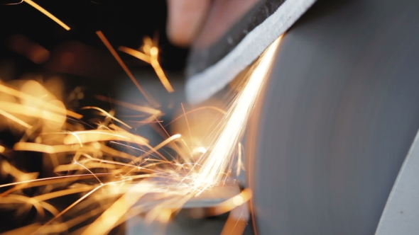 Man Sharpens The Ax At Home.