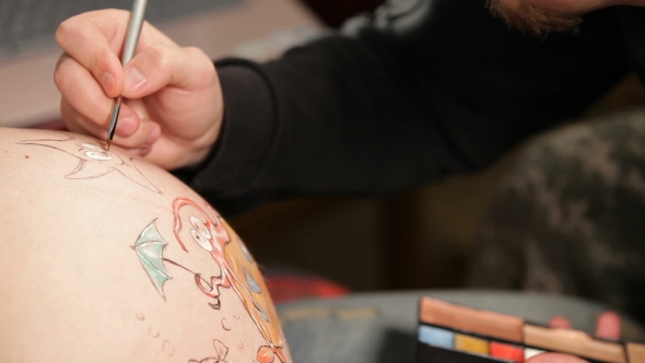 Artist Drawing On Pregnant Belly