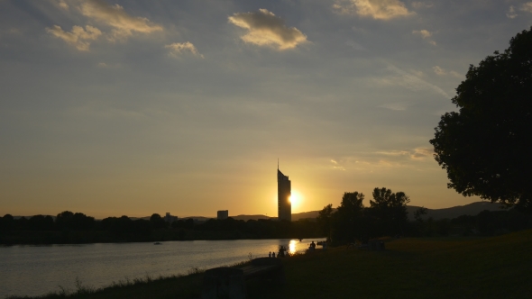 Sunset In Park. Silhouette Of Cityscape