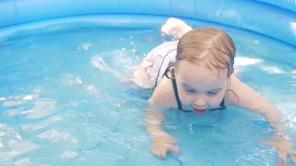 A Girl in an Inflatable Pool