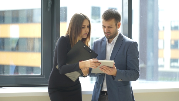 Successful Businessmen Discussing Business Plan Near The Window alt