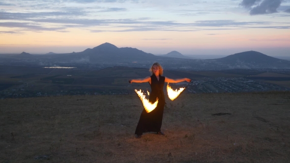 Woman Twirling Burning Torch
