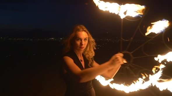 Young Blonde Woman With Flaming Torches
