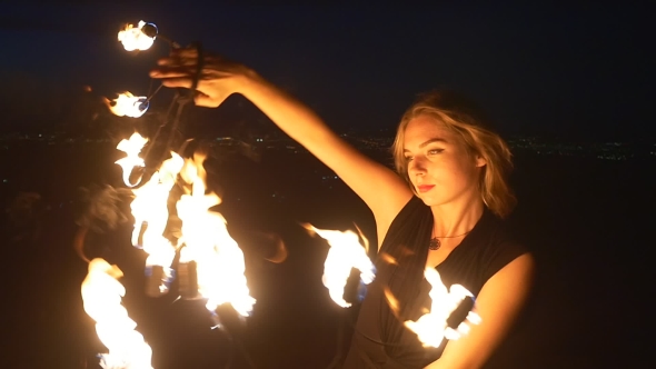 Woman Spins Burning Torch