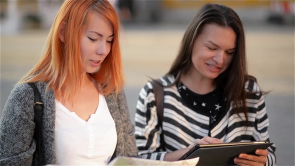 Two Young Girls On The Streets Of The Old City. Girlfriends Try To Find Their Way In An Unfamiliar alt