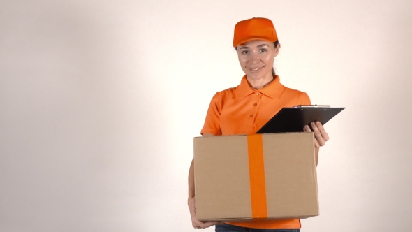 Girl Courier In Orange Uniform Delivering a Big Carton. Light Gray Backround,  Studio Shot alt