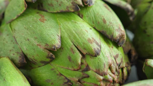 Whole Fresh Artichokes on Plate alt