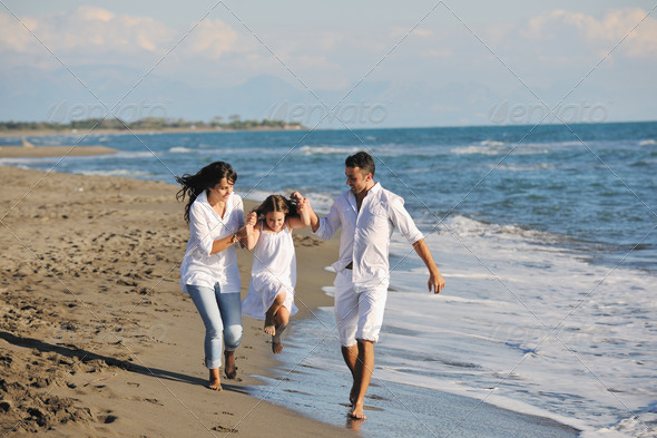 happy young  family have fun on beach - Stock Photo - Images