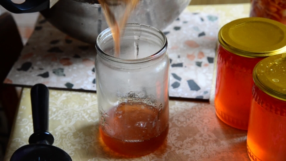 Housewife Pours Homemade Jam in Jar