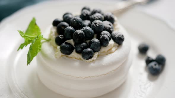 Delicious Mini Pavlova Meringue Nest with Blueberry and Mint Leaves