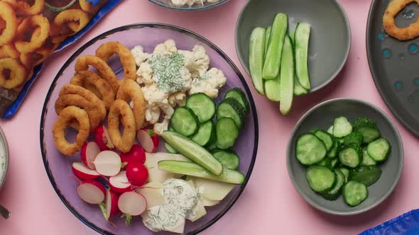 Flat Lay Food Video the Cook Puts Plate of Fresh Vegetables and Fried Onion Rings to the Table