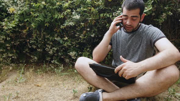 Young Man Is Talking With Cellphone In Nature 2 alt