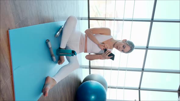 Young Sporty Girl Showing Exercises Online Using Smartphone alt