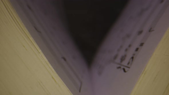 Macro Shot Through Musical Notes Inside of Book As It Opens alt