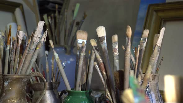 Artist's art tools in the art studio. Oil painting in creative workroom alt