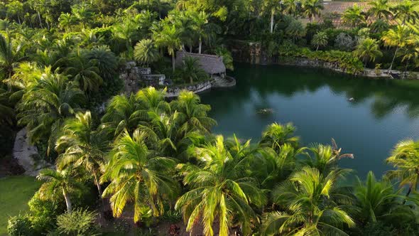Aerial view of a tiki next to a lake on a sunny and beautiful afternoon in South Florida alt