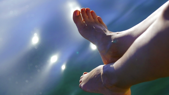 Legs Of a Beautiful Girl On a Background Of Water - Sun Glare In The Water alt
