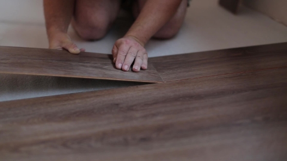 Worker Puts The Board Flooring