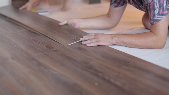 Worker Puts The Board Flooring