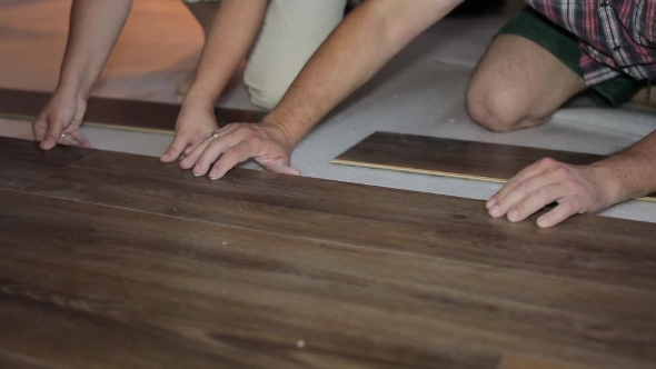 Worker Puts The Board Flooring