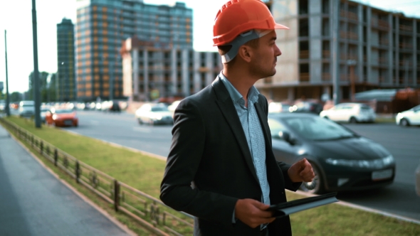 Architect Looking Tablet Pc And Comparing Project With Building alt