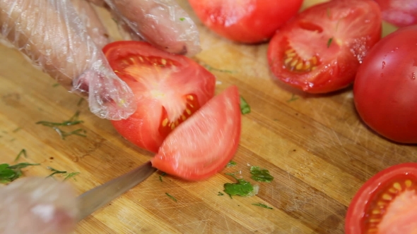 Hands Cut Tomatoes For Salad