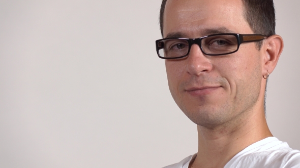 Portrait Of a Programmer In Black Rim Glasses Against Gray Background.   Shot alt