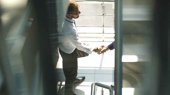 Handshake Of Business Partners Met On The Stairs In The Office Building alt