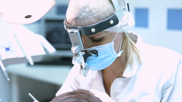 Dentist In Mask And Flashlight At Work alt