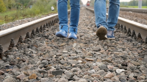 Couple Walking On Railroad Tracks alt