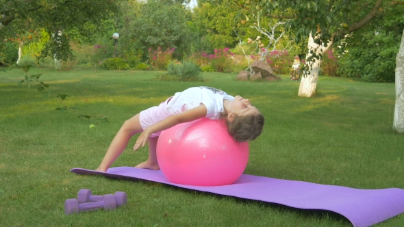 The Girl Doing The Exercises With Ball In The Garden alt