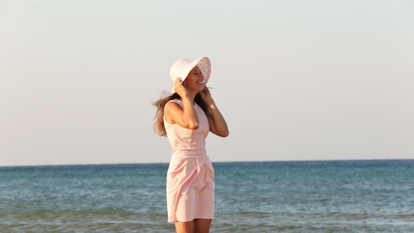 Girl In Hat On The Beach