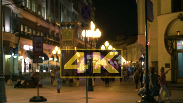 People And Cars In The City At Night By The Street Lighting And Car Headlights alt