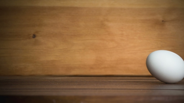 An Egg Is Rolling Across The Table. .