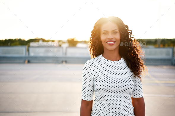 Smiling woman in polka dot blouse