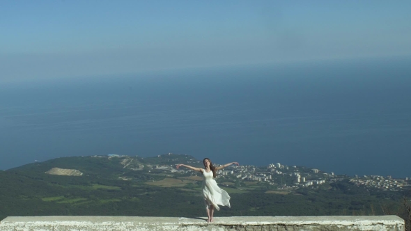 Girl Raises Her Arms And Smiles alt